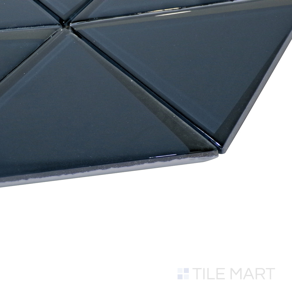 The striking blue triangle pattern catches light from the side, showcasing the smooth glass texture and geometric layout.