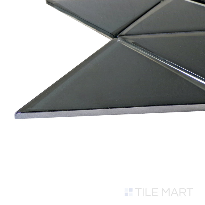 A corner perspective of the Modern Glass Dark Grey 6" Triangle glossy mosaic tile emphasizes its dark gray hue and reflective surface, bringing an edgy and contemporary look to interiors.