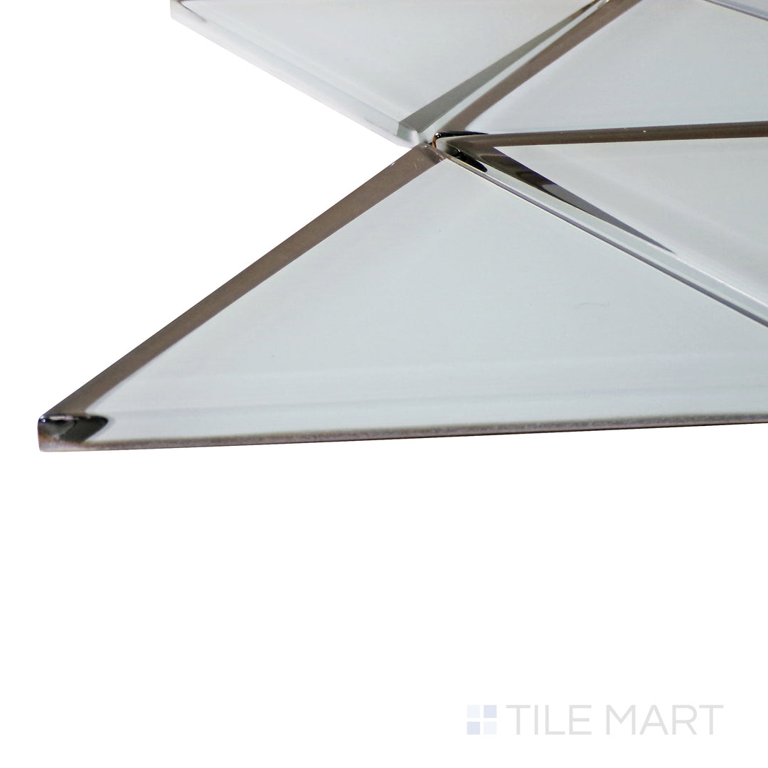 Captured from a corner angle, the Modern Glass Grey 6" Triangle glossy mosaic tile showcases its soft gray tones and triangular formation, adding subtle depth and texture to designs.