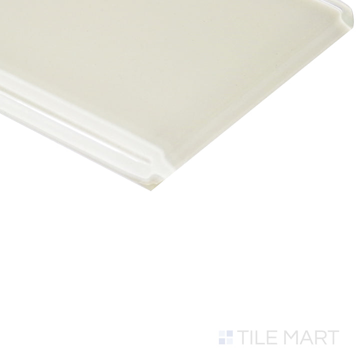 From an angled view, the pastel yellow glass tile reflects light beautifully, showcasing its polished surface with a radiant glow.