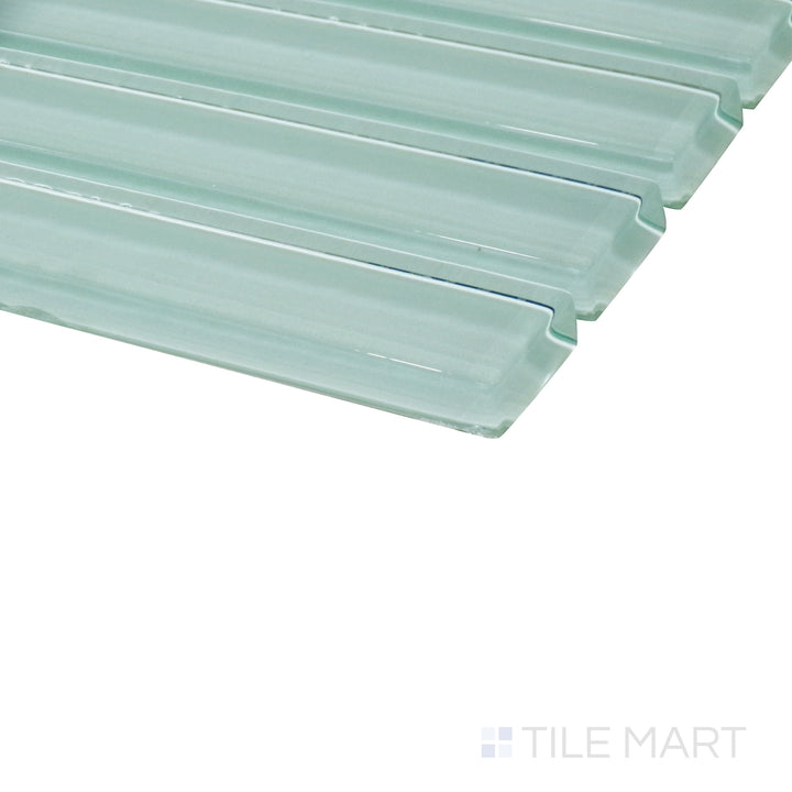 An angled close-up highlights the soft green tones of this glossy grid mosaic, revealing its reflective surface and structured layout.