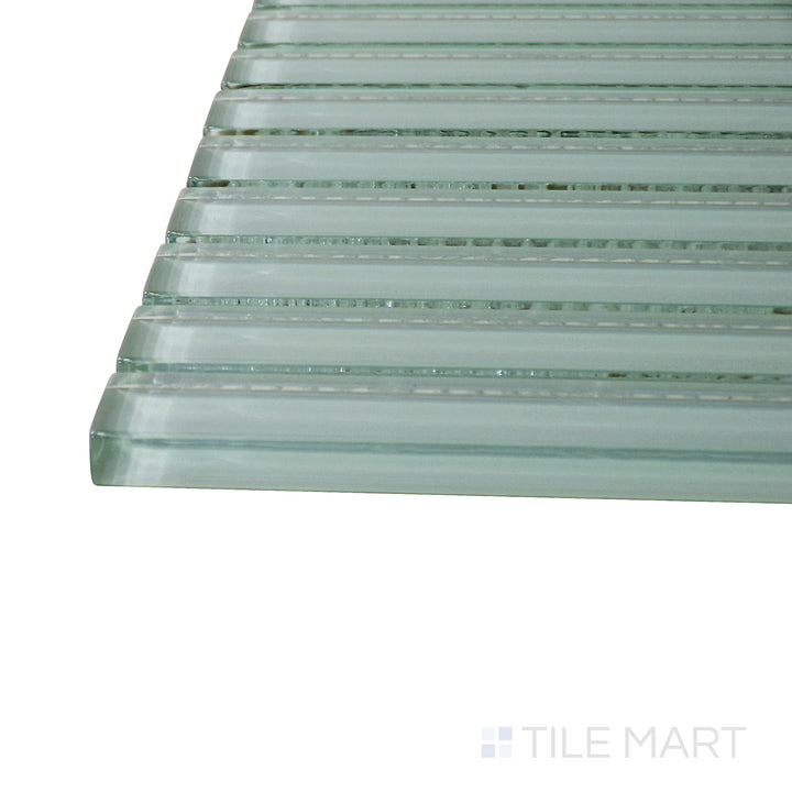 Captured from a corner angle, the Glass Pastel Green Grid glossy mosaic tile showcases its muted green hue and precise grid design, perfect for modern and nature-inspired spaces.