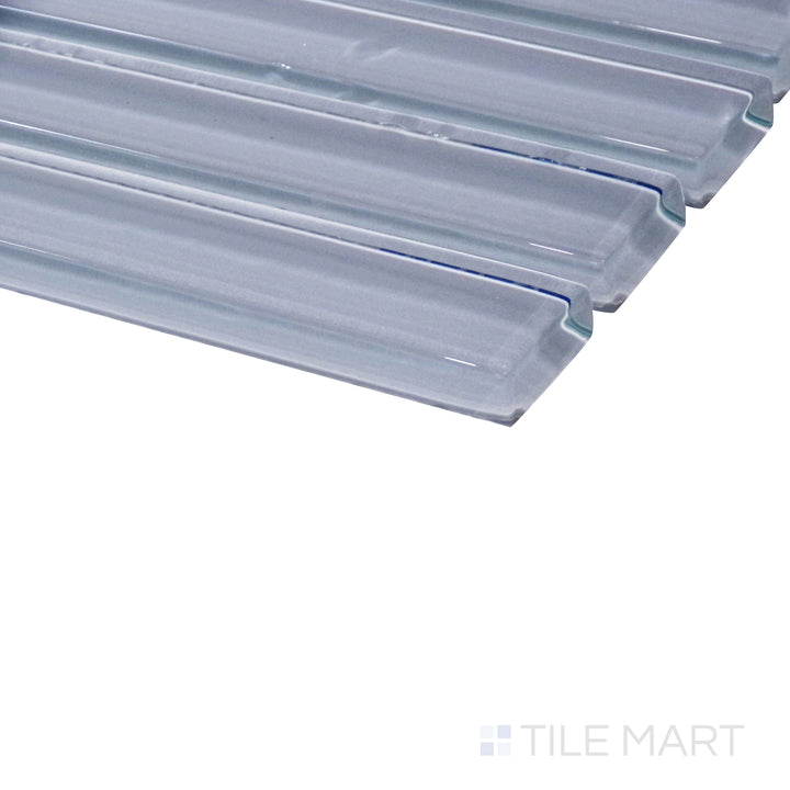 An angled close-up highlights the soft green tones of this glossy grid mosaic, revealing its reflective surface and structured layout.