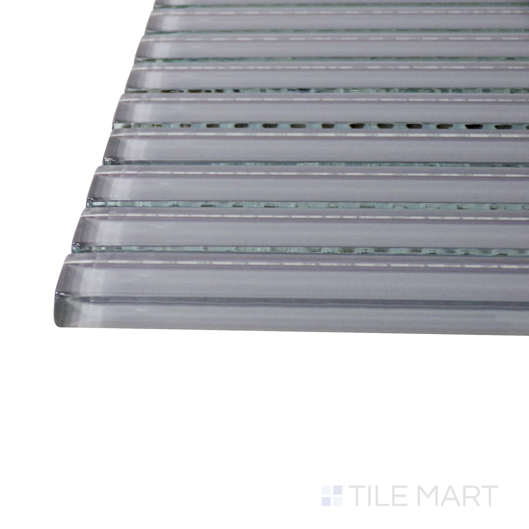 A corner perspective of the Glass Pastel Grey Grid glossy mosaic tile emphasizes its subtle gray shade and polished finish, offering a neutral yet stylish accent for walls and backsplashes.