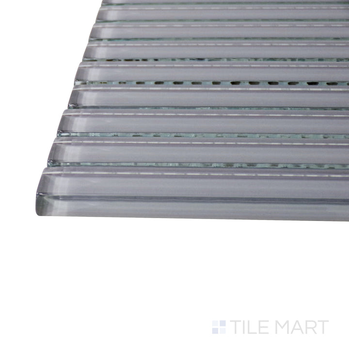 A corner perspective of the Glass Pastel Grey Grid glossy mosaic tile emphasizes its subtle gray shade and polished finish, offering a neutral yet stylish accent for walls and backsplashes.