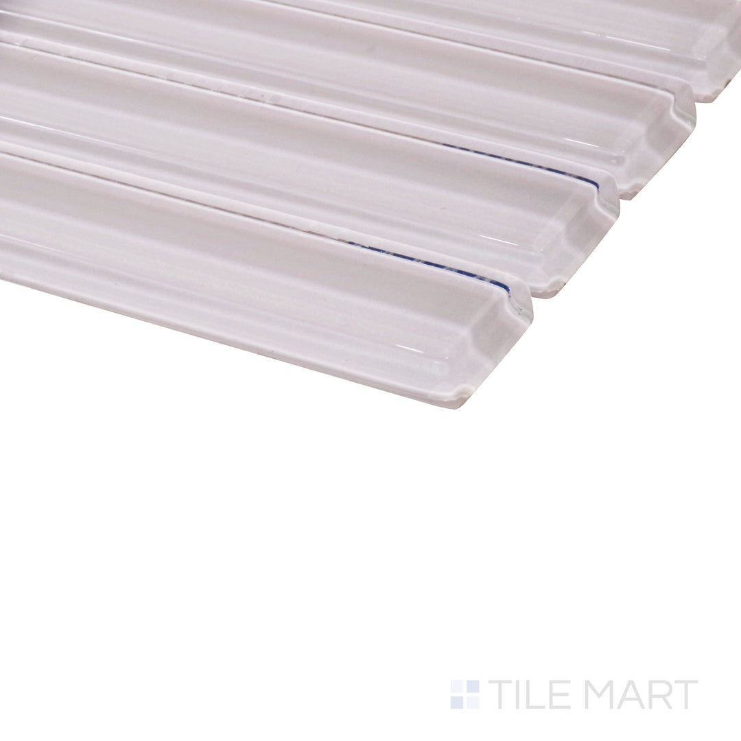 A delicate pastel pink hue shines under the light in this angled shot, emphasizing the glossy texture and geometric grid design.