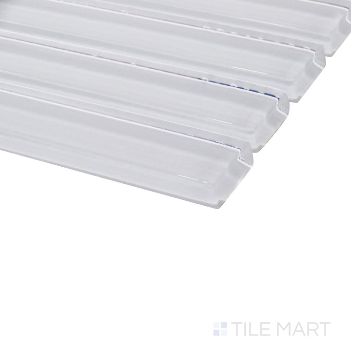 Viewed from an angle, the glossy pastel white grid mosaic creates a luminous effect, showcasing its pristine finish and seamless structure.