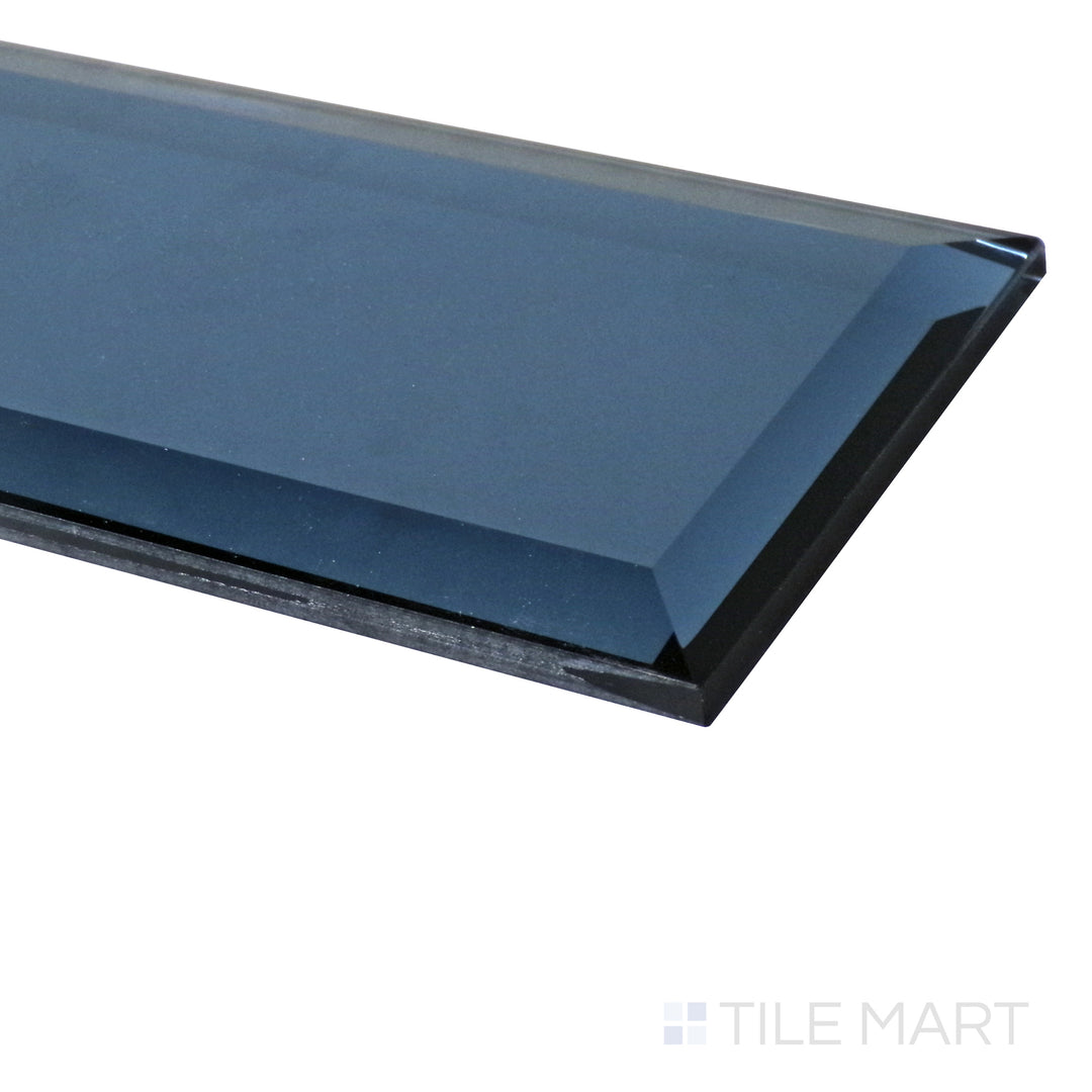 A dramatic angle highlights the steel glass tile’s beveled design, showcasing its sharp definition and radiant glossy shine.