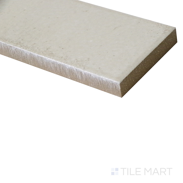 A close-up angle highlights the soft beige hue of this glossy porcelain tile, reflecting light for a smooth, polished look.