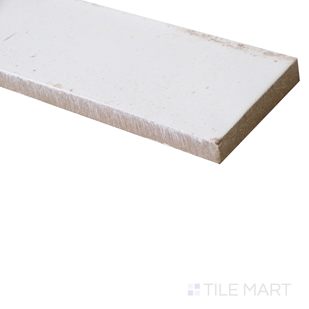 Captured from an angle, this glossy Bianco porcelain tile showcases a pristine white finish with a sleek, luminous surface.