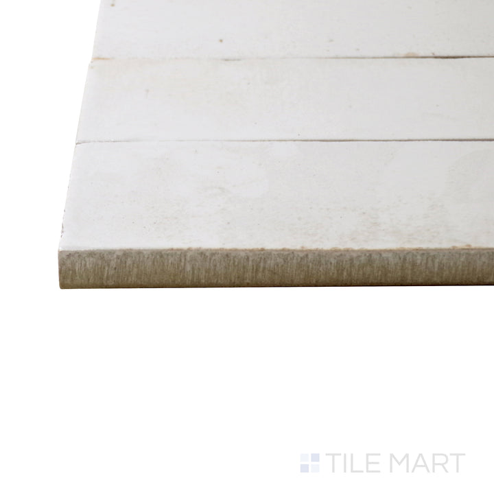 Captured from a corner angle, the Gleeze Bianco 2x6 glossy porcelain tile showcases its crisp white shade and high-gloss finish, bringing a clean and timeless appeal to walls and backsplashes.