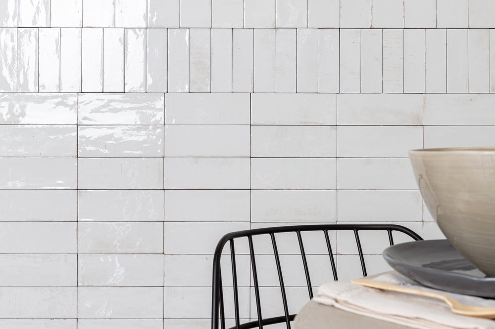 A bright and airy lifestyle setting showcasing Gleeze Bianco glossy porcelain, exuding timeless elegance.