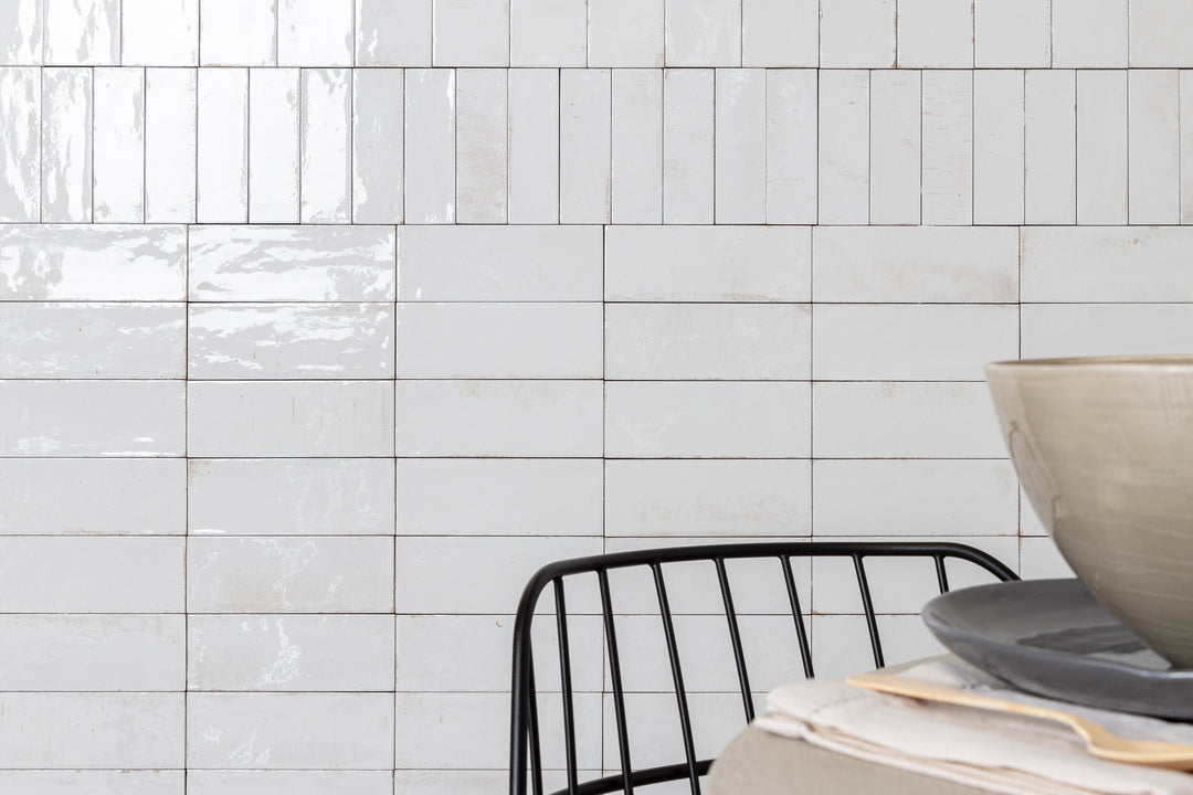 A bright and airy lifestyle setting showcasing Gleeze Bianco glossy porcelain, exuding timeless elegance.