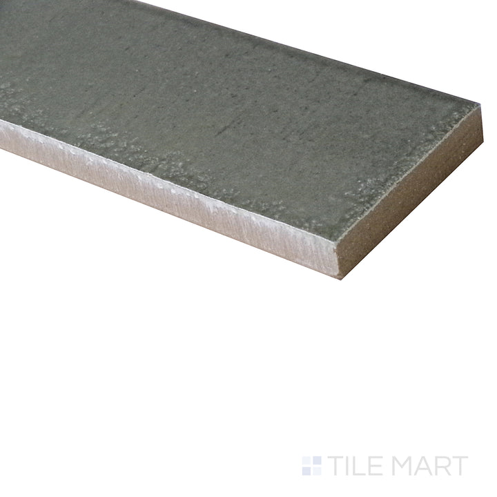 A side-angle view highlights the cool gray tones of this glossy Grigio porcelain tile, emphasizing its reflective, modern finish.