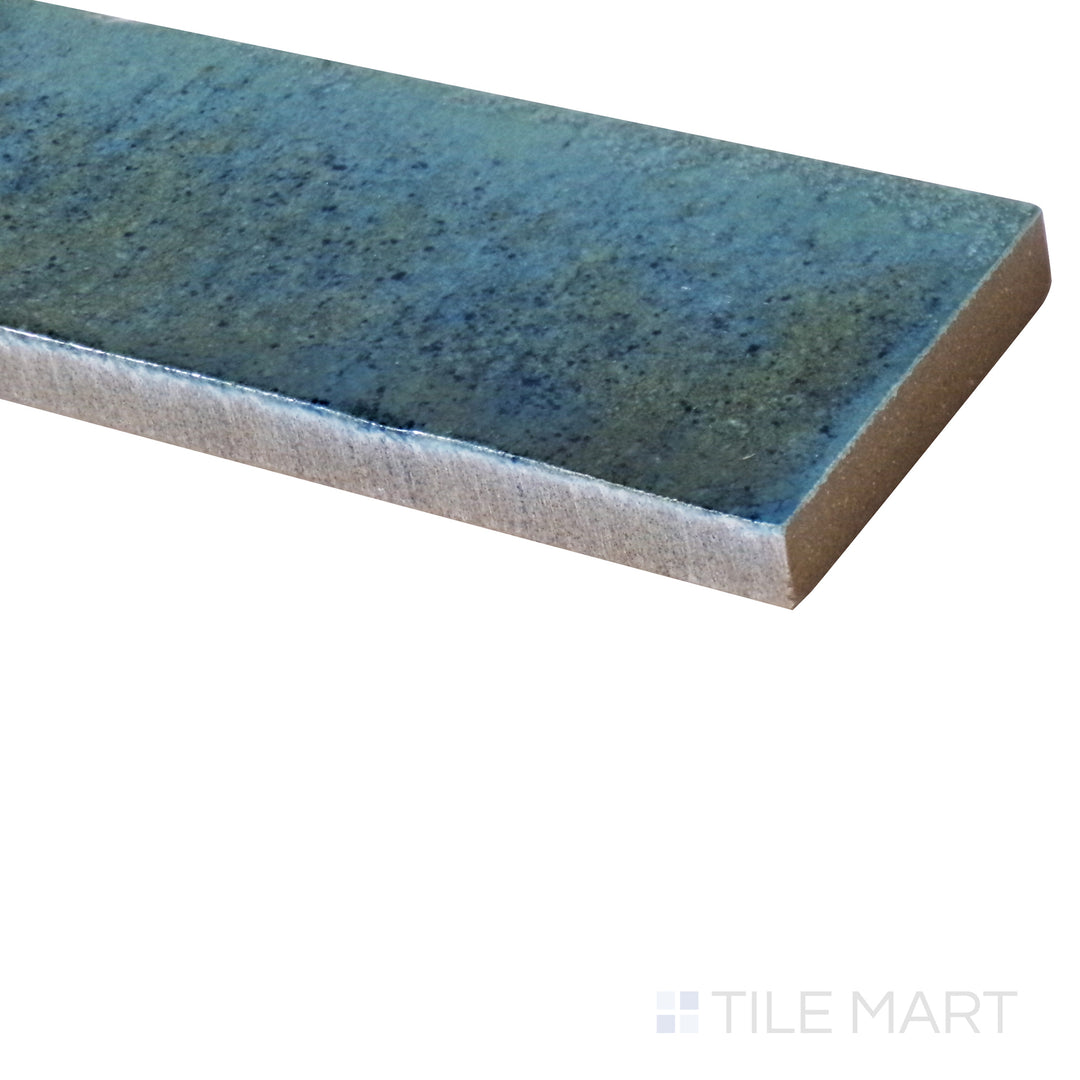 An angled shot captures the vibrant Turchese blue glossy tile, showcasing its striking color and smooth, polished surface.