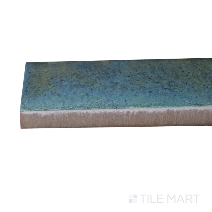 Captured from a corner angle, the Gleeze Turchese 2x6 glossy porcelain tile showcases its striking turquoise shade and polished surface, adding vibrancy and character to tiled spaces.