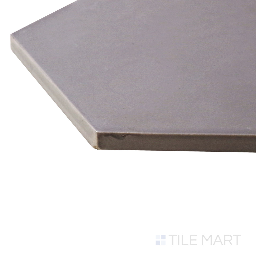 A corner perspective of the Hexatile Gris 8" hexagon matte porcelain tile emphasizes its soft gray hue and contemporary hexagonal design, blending elegance with industrial charm.