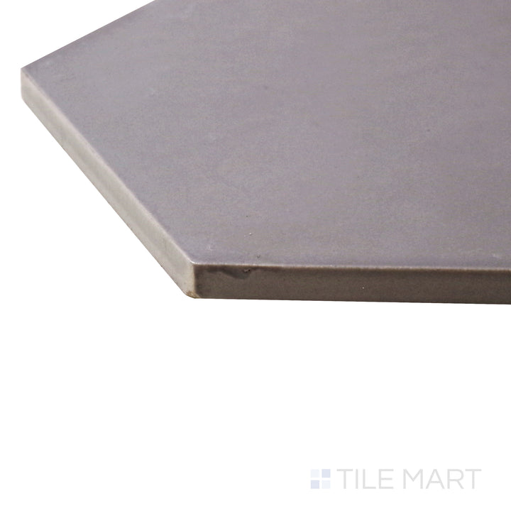 A corner perspective of the Hexatile Gris 8" hexagon matte porcelain tile emphasizes its soft gray hue and contemporary hexagonal design, blending elegance with industrial charm.