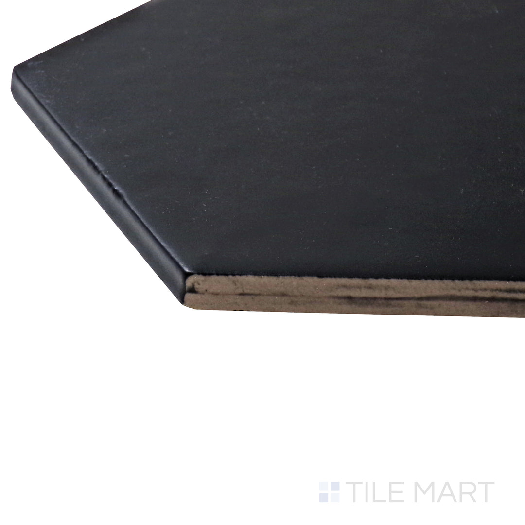 A corner shot of the Hexatile Negro 8" hexagon matte porcelain tile highlights its deep black tone and matte surface, creating a bold and striking visual impact.