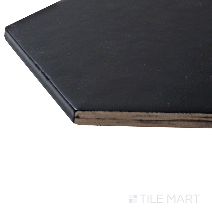 A corner shot of the Hexatile Negro 8" hexagon matte porcelain tile highlights its deep black tone and matte surface, creating a bold and striking visual impact.