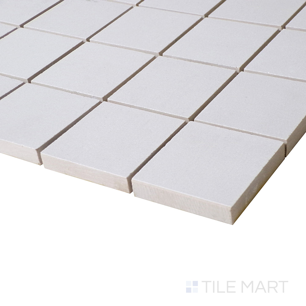 A soft-angled shot enhances the clean, bright surface of this Blanco square mosaic, making it a versatile matte option.