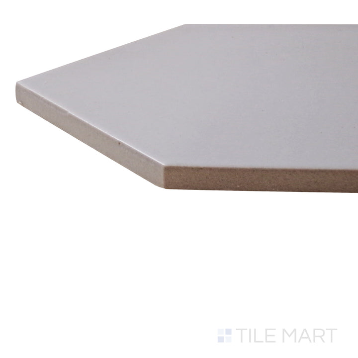 A corner perspective of the Kite Light Grey 4x12 matte porcelain tile emphasizes its soft gray tone and smooth matte surface, offering a sleek and neutral design element.