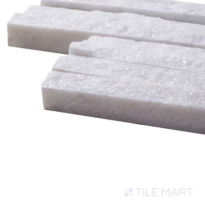 A corner shot of the Contemporary Mini Ledgestone Snowfall 6x24 natural stone tile highlights its soft white and gray mix with a natural textured surface, creating a timeless and versatile accent.