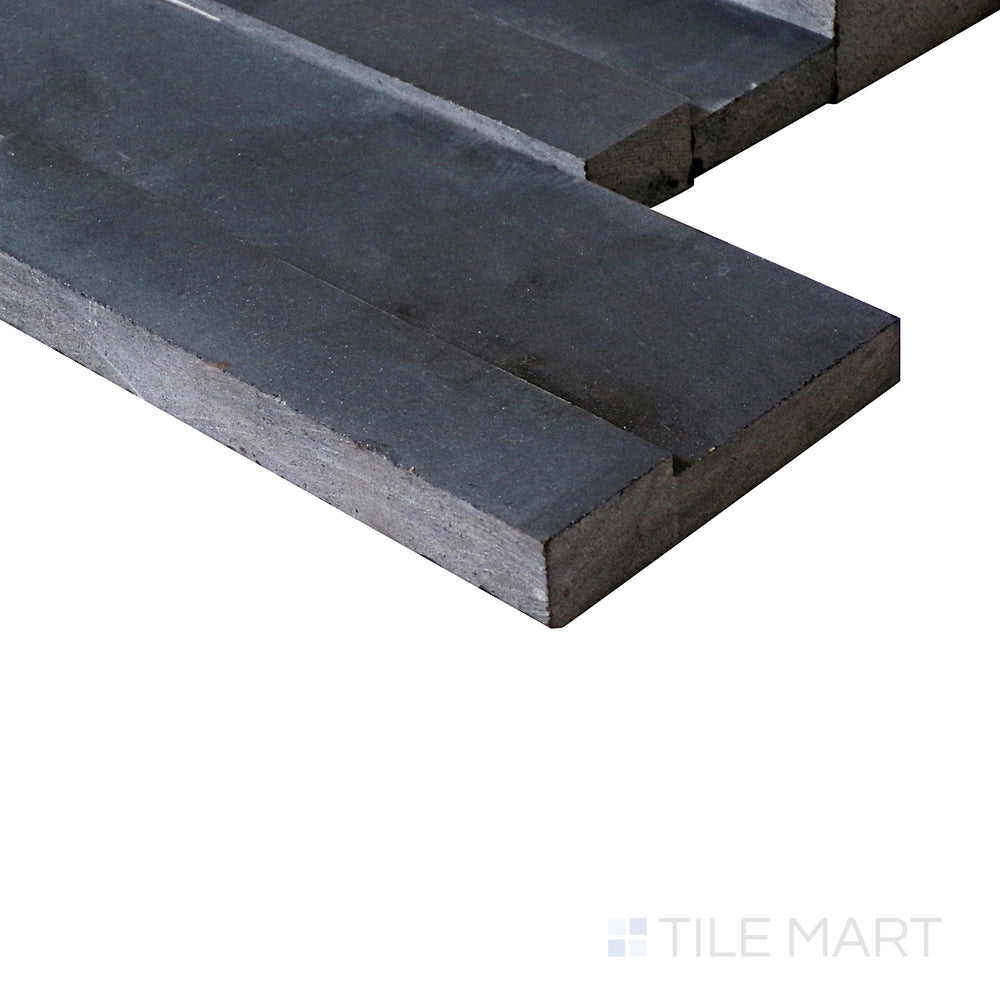 A side-angle view showcases the dramatic black finish of this ledgestone porcelain tile, bringing out its bold, textured surface.