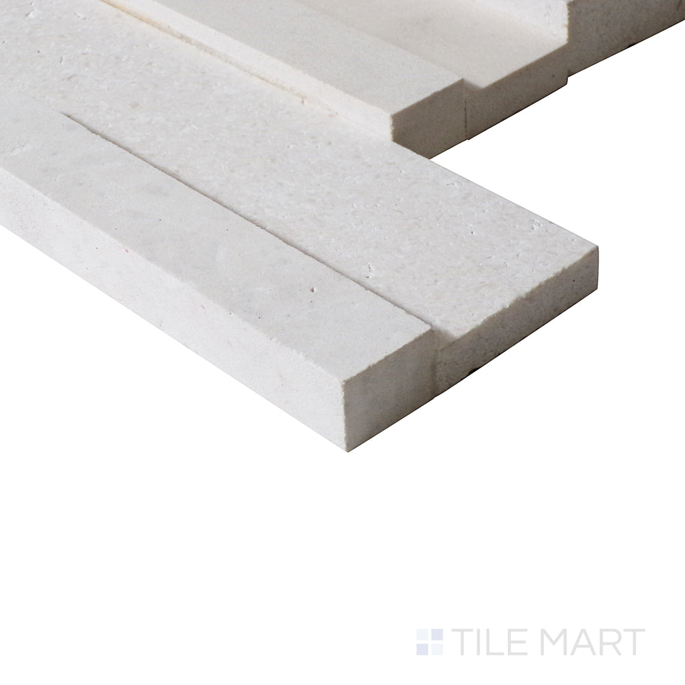 An angled close-up highlights the fresh white tones and structured texture of this Blanc ledgestone tile, enhancing its modern aesthetic.