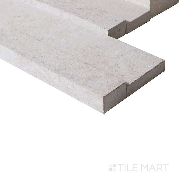 A close-up from an angle captures the warm, creamy tones and gentle texture of this ledgestone tile, adding a natural softness.