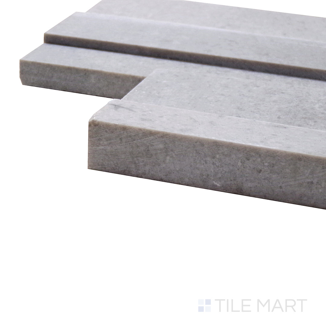 Captured from a corner angle, the Modern Ledgestone Milano Grey 6x24 porcelain tile showcases its cool gray hues and rugged stone effect, perfect for modern and industrial interiors.