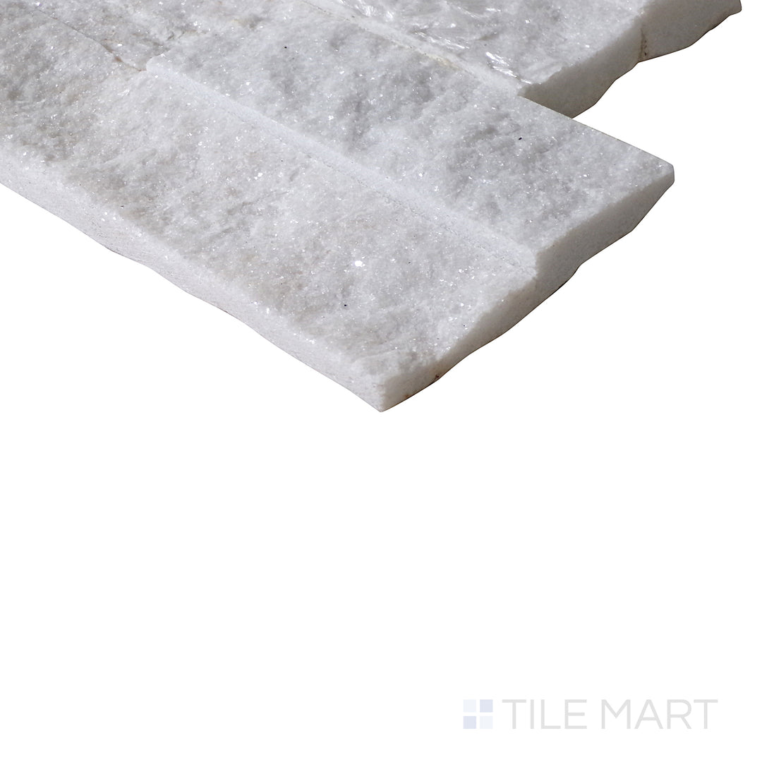 A close-up from an angle highlights the crisp white tones and rugged surface of Glacier White splitface stackstone for a natural, fresh look.