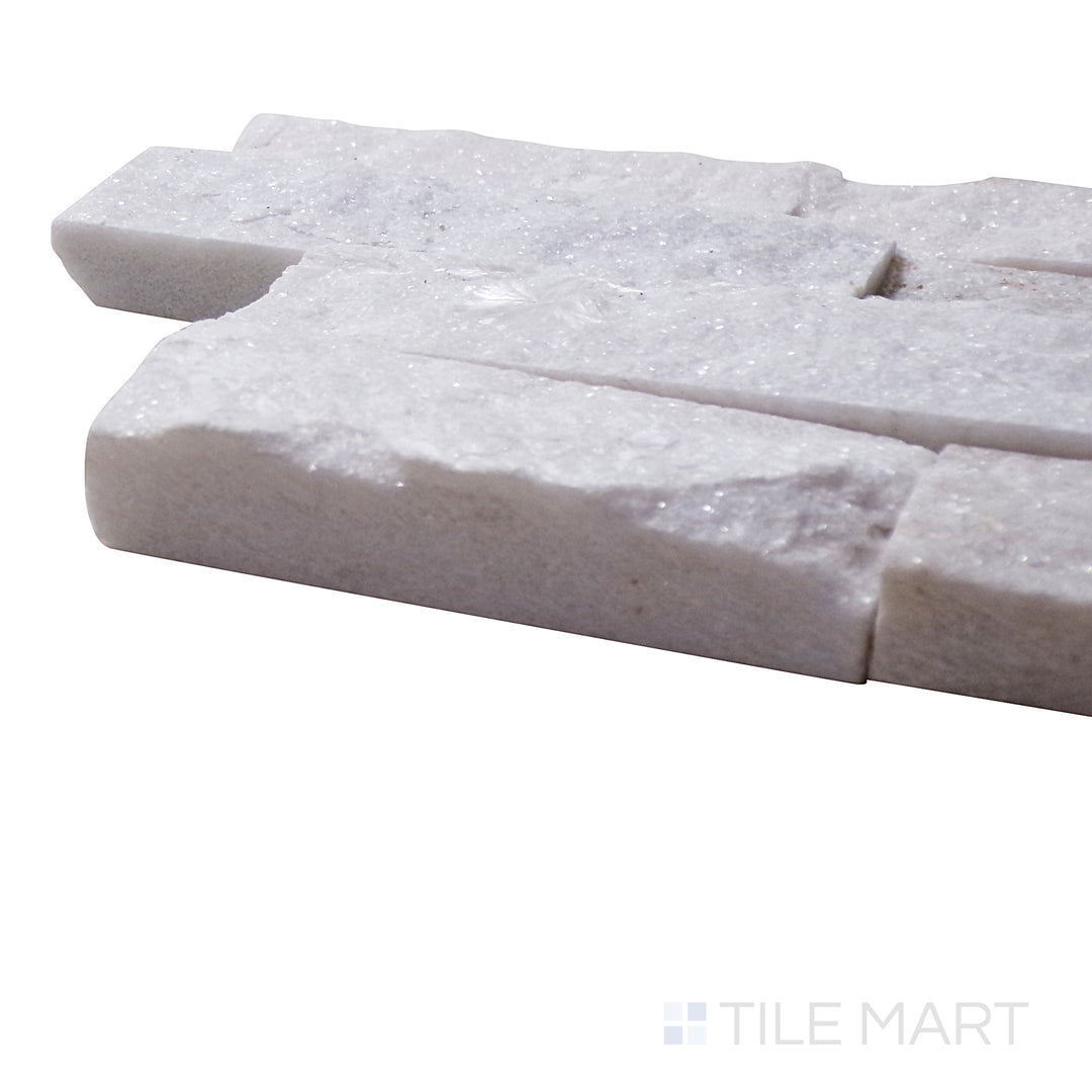 A corner shot of the Natural Splitface Stackstone Panels Glacier White 6x24 highlights its bright white and gray hues, creating a fresh and modern stacked stone effect.