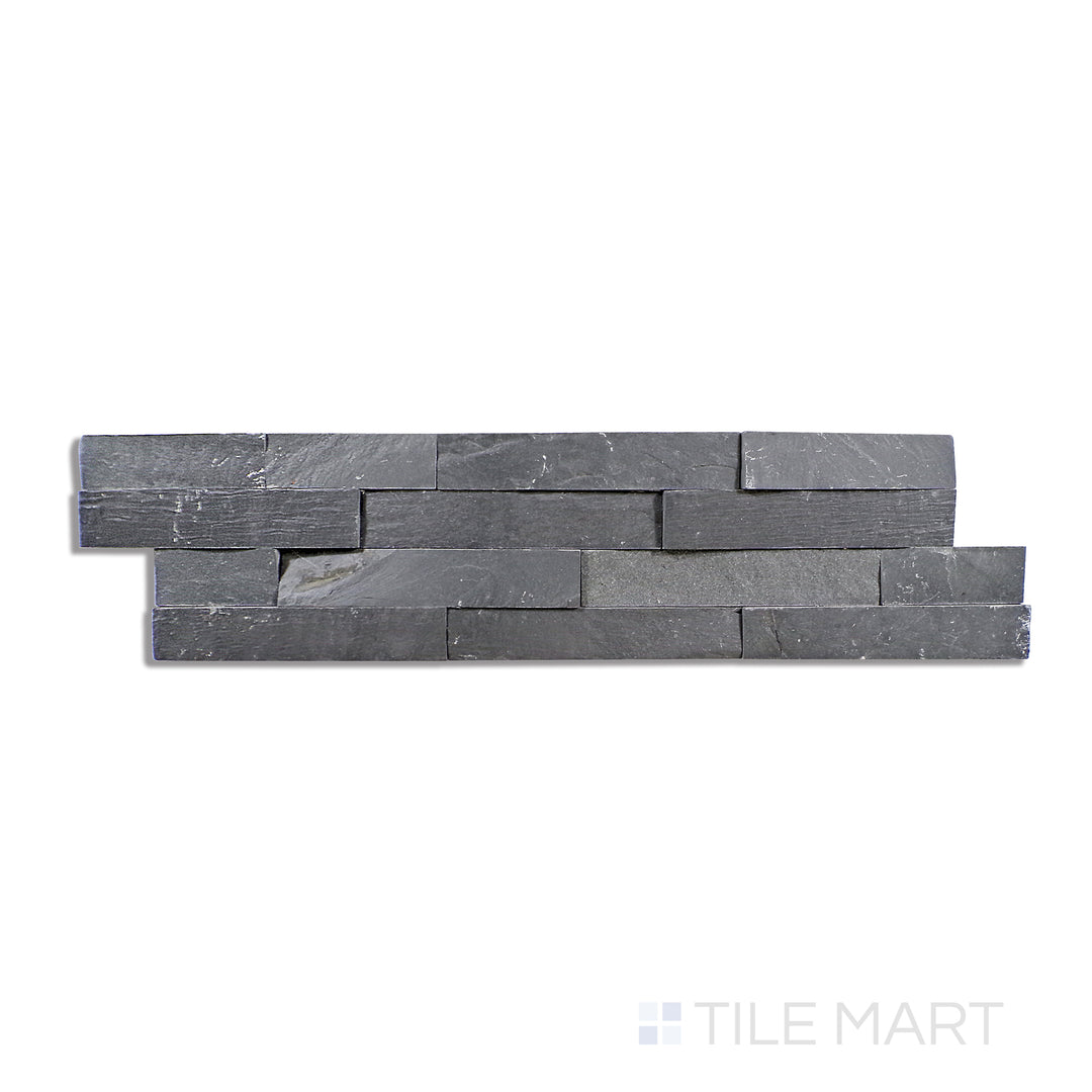 Flat lay of Natural Splitface Stackstone Panels Midnight 6X24, showcasing deep, dramatic black stone with a bold, rugged texture.