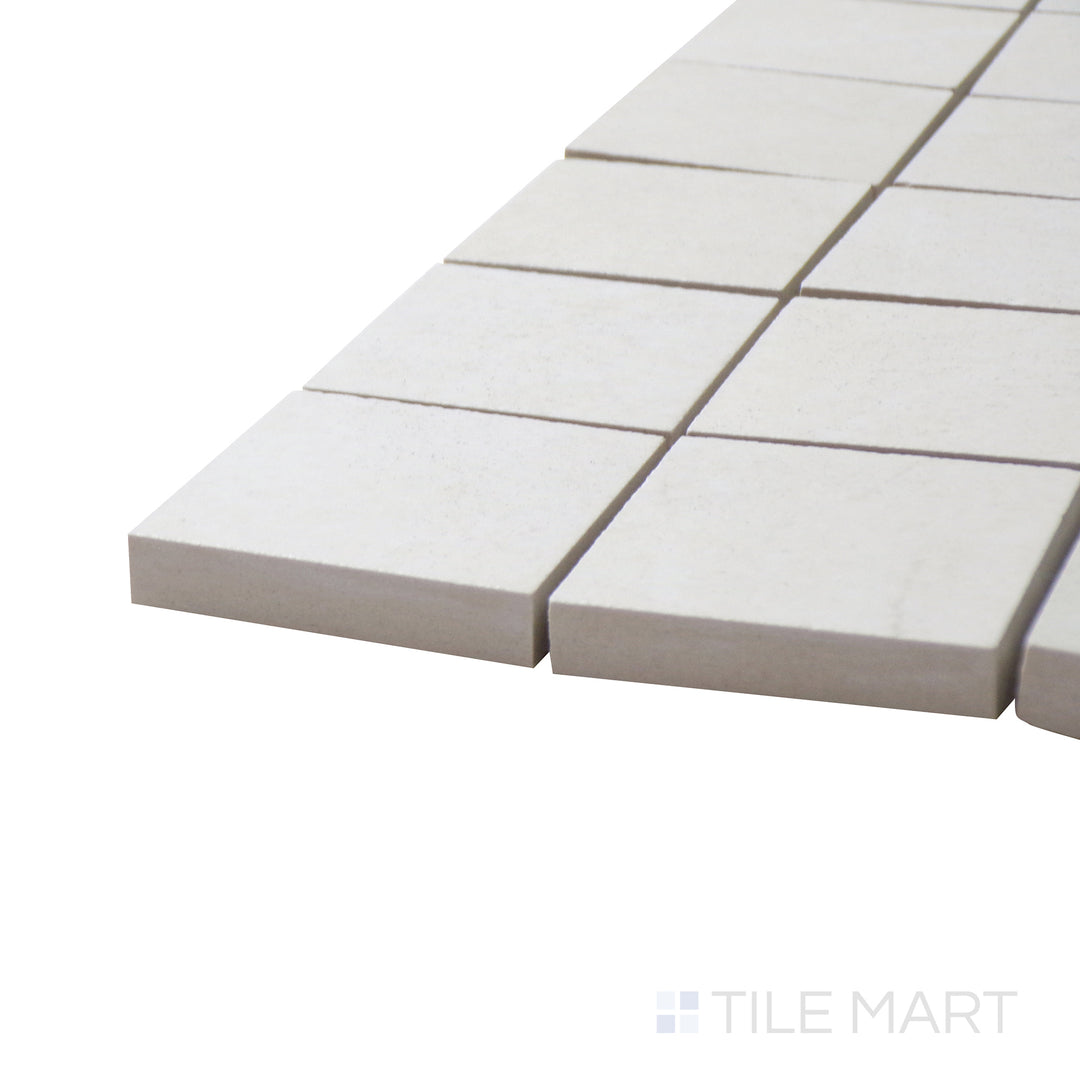 A corner perspective of the Lugano Marfil 2" square polished porcelain mosaic tile emphasizes its soft beige hues and high-gloss texture, adding depth and luxury to accent walls and floors.