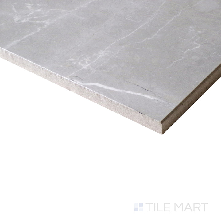 A close-up from an angle highlights the soft, smoky tones of Amani Grey porcelain, with a reflective polished finish that enhances its depth.