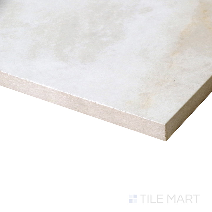 An angled shot emphasizes the soft cream tones and fluid veining of Kristalus Cream porcelain, bringing warmth and sophistication to the surface.