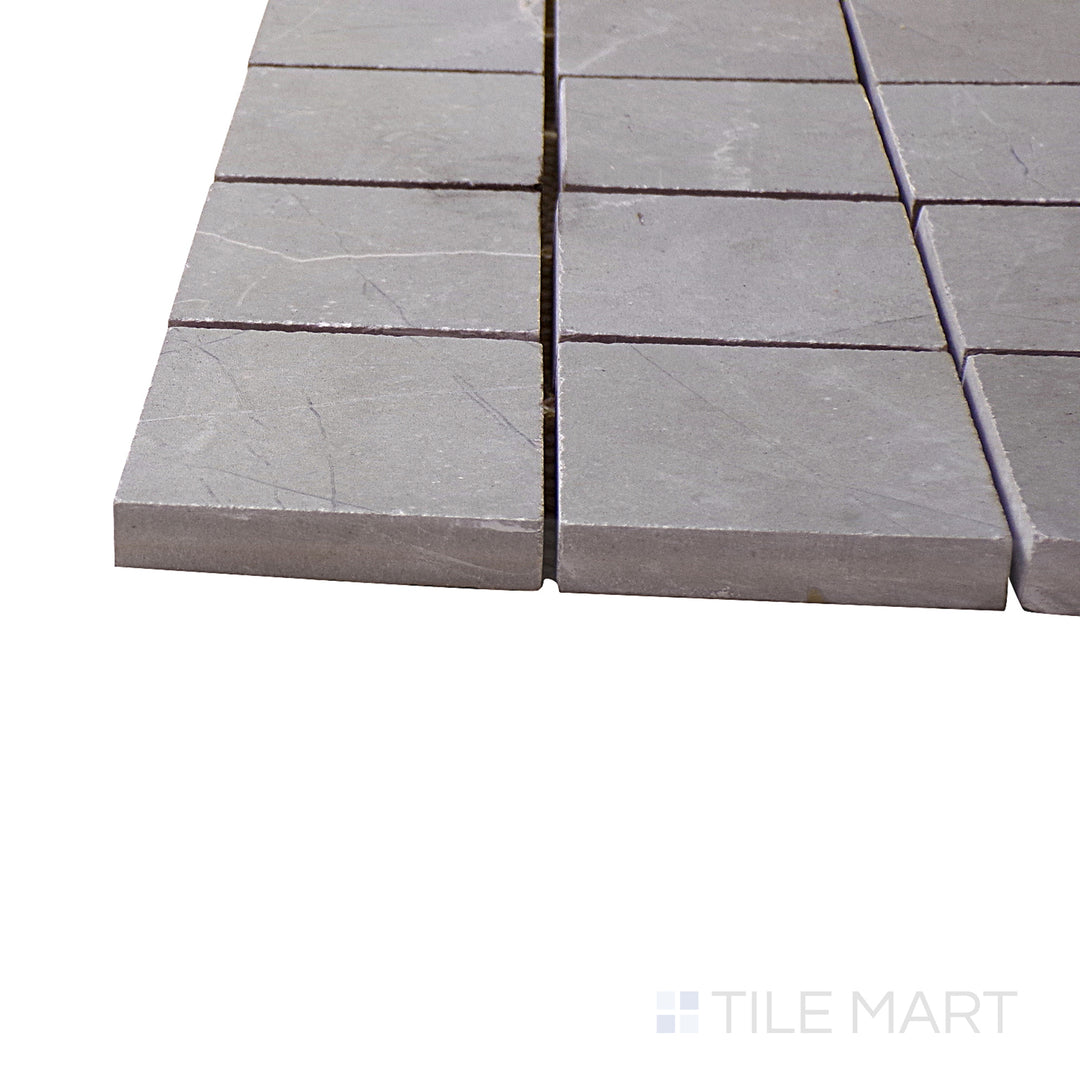 A corner shot of the Luxury Amani Grey 2" square polished porcelain mosaic tile highlights its refined gray shade and structured layout, ideal for adding texture to feature walls and floors.