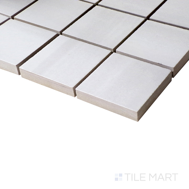 Luxury Deodat White 2" Square Polished Porcelain Mosaic in an angled shot, emphasizing its crisp white surface and smooth finish.