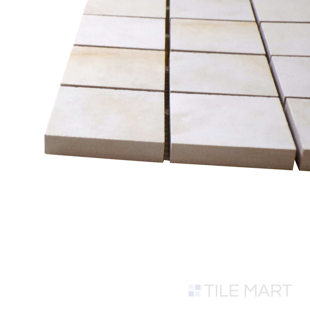 A corner shot of the Luxury Kristalus Cream 2" square polished porcelain mosaic tile highlights its soft cream tones and smooth polished surface, perfect for refined and neutral design schemes.