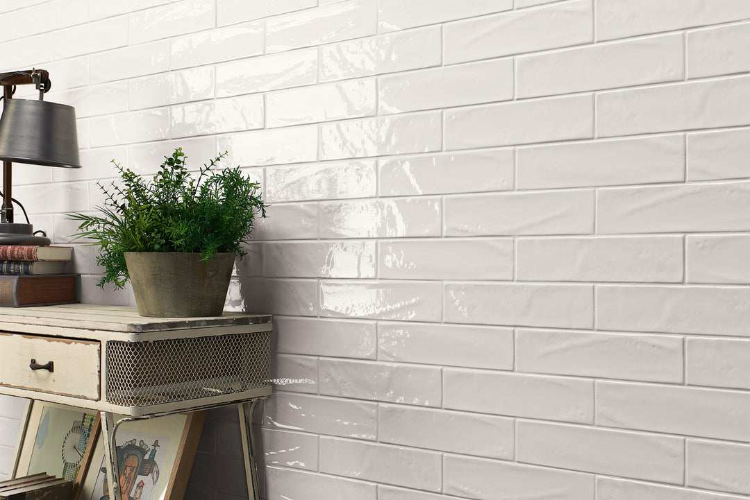 Manhattan Ceramic 1st Ave 3x12 glossy tile installed in a finished design, showcasing its bold blue color, reflective glaze, and elongated form.