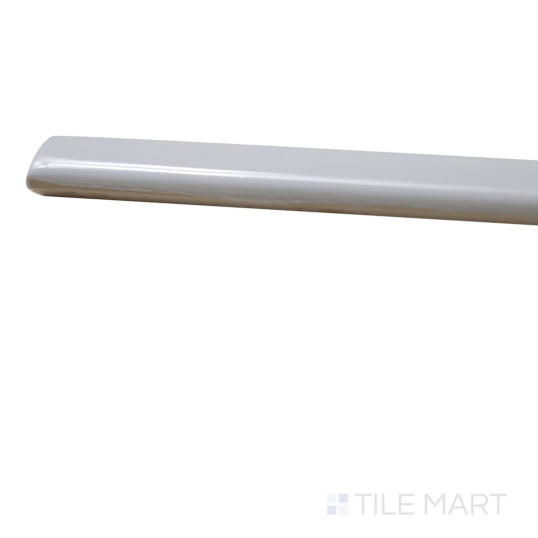 Angled view of Manhattan Ceramic 1st Ave 0.5x12 glossy demi-bullnose tile showing rounded bullnose edge and polished finish