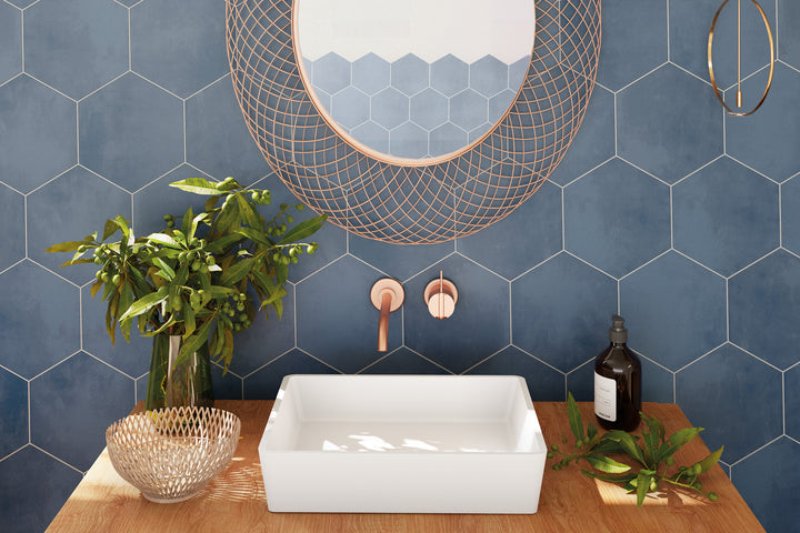 A dynamic roomscene featuring Meraki Base Azul 8" hexagon matte porcelain, delivering a bold and contemporary aesthetic.