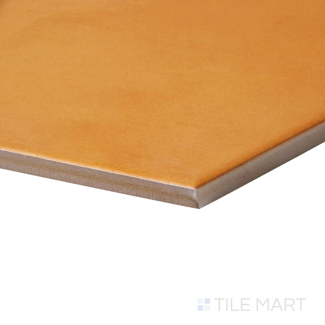 Angled shot featuring the bold golden hue of Meraki Base Mostaza 8" hexagon matte porcelain tile.