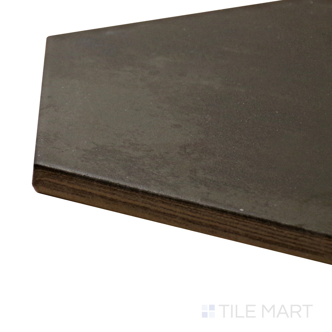 A corner perspective of the Meraki Base Negro 8" hexagon matte porcelain tile emphasizes its deep black shade and structured hexagon design, perfect for a bold and sophisticated aesthetic.