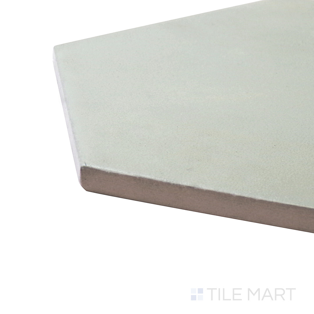 Captured from a corner angle, the Meraki Base Verde 8" hexagon matte porcelain tile showcases its lush green tone and geometric layout, bringing an earthy and natural feel.