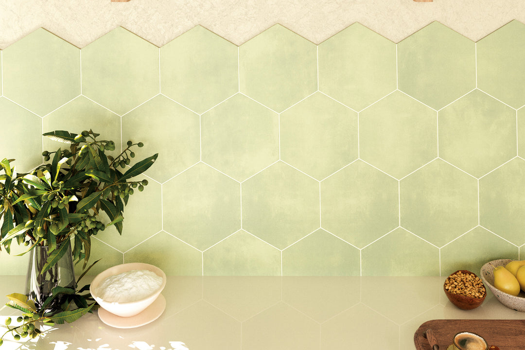 An earthy and refreshing atmosphere featuring Meraki Base Verde 8" hexagon matte porcelain, inspired by natural green elements.