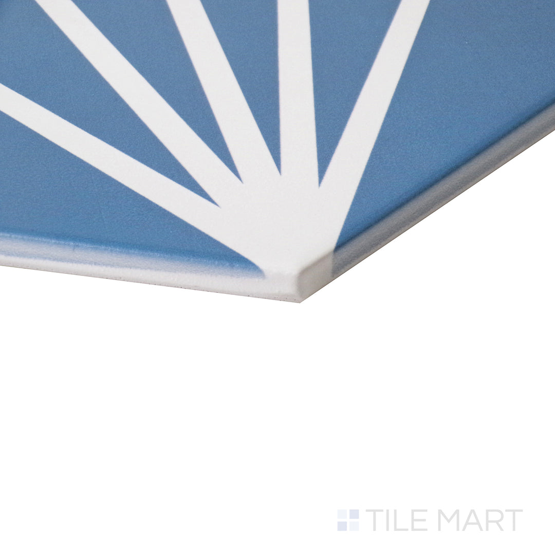 Tilted shot capturing the bold geometric design of Meraki Even Deco Azul 8" hexagon matte porcelain tile.