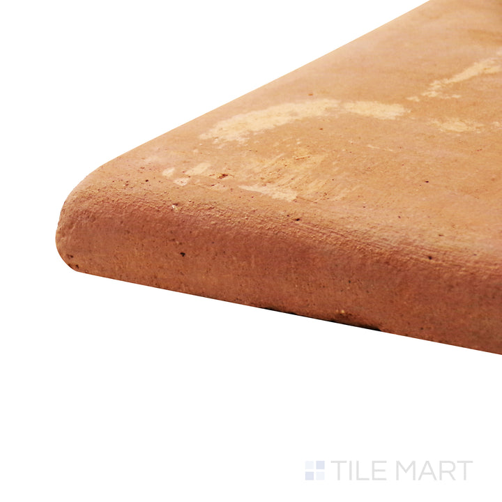 A corner shot of the Lincoln Pavers Red 12x12 stair coping corner natural terracotta tile highlights its rounded edge and durable construction, designed for seamless step transitions.