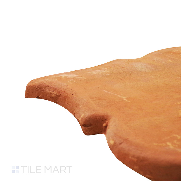 Captured from a corner angle, the Lincoln Pavers Red 8x9 Riviera natural terracotta tile showcases its organic red tones and distinctive shape, adding character to walkways and courtyards.